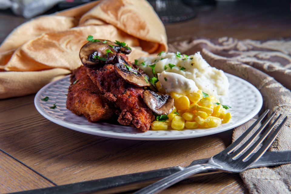 Crispy breaded chicken marsala with mashed potatoes and kernel corn