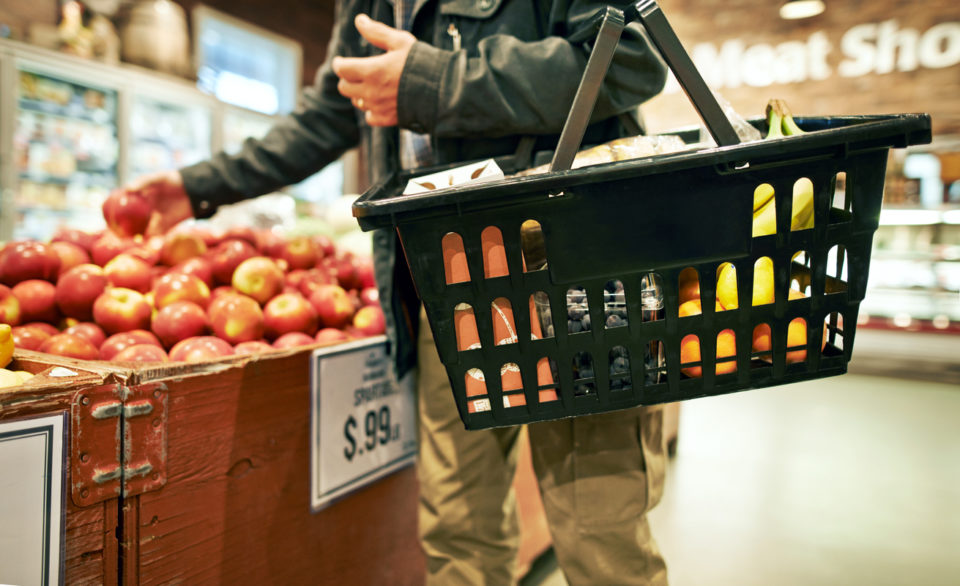 Cropped shot of a man shopping for apples in a grocery store