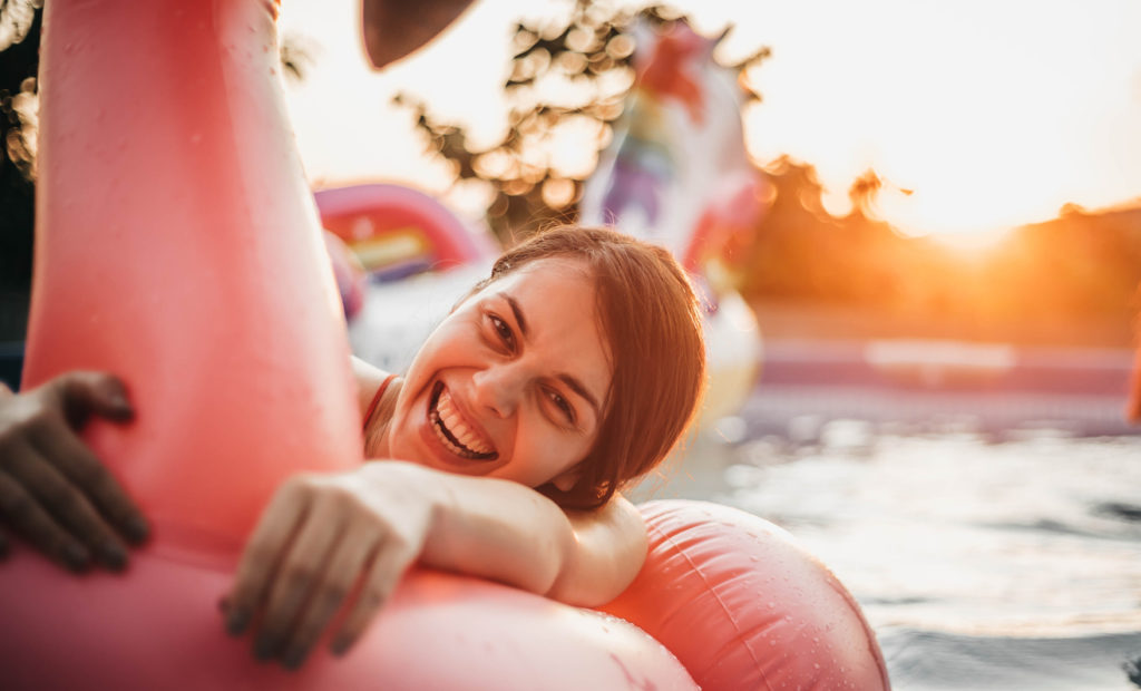 Woman happily relaxing on a pool float