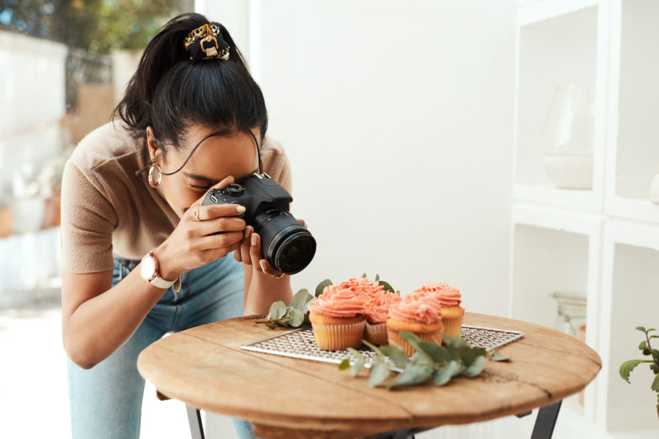 Photographer capturing photo of cupcakes