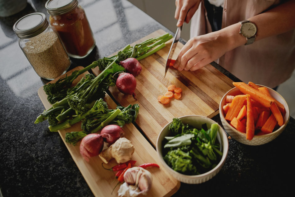 Female hands cutting vegetables