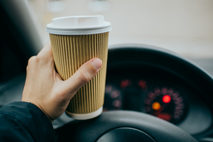 Holding a cup of a drink