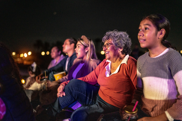 Group of people enjoying a movie at the outdoors cinema