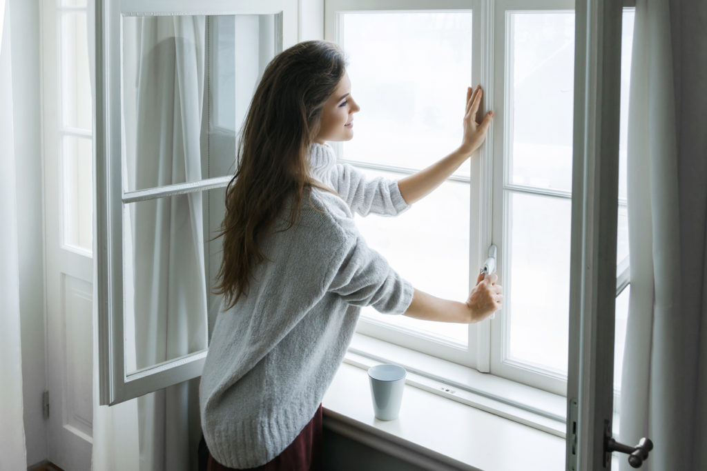 woman sealing the window